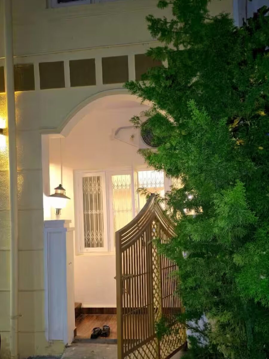 Arched garden gate entrance to The Garden City Nest at night