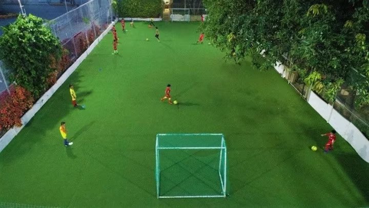 Astro-turf football pitch lit up at night