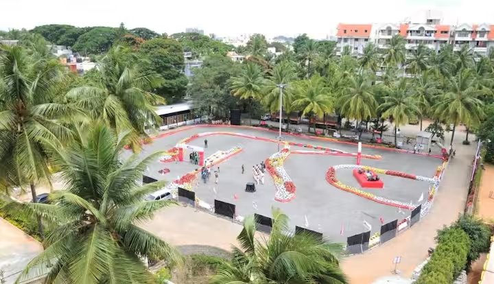 Aerial view of the go-kart track lined with palm trees